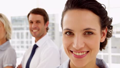 Business-people-smiling-at-the-camera