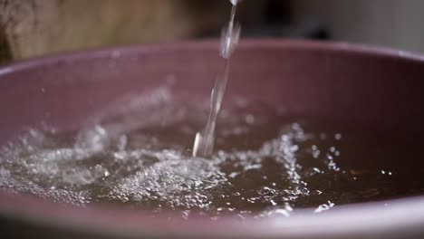 gentle ripples in water as rain falls, slow-motion shot in manaus, brazil