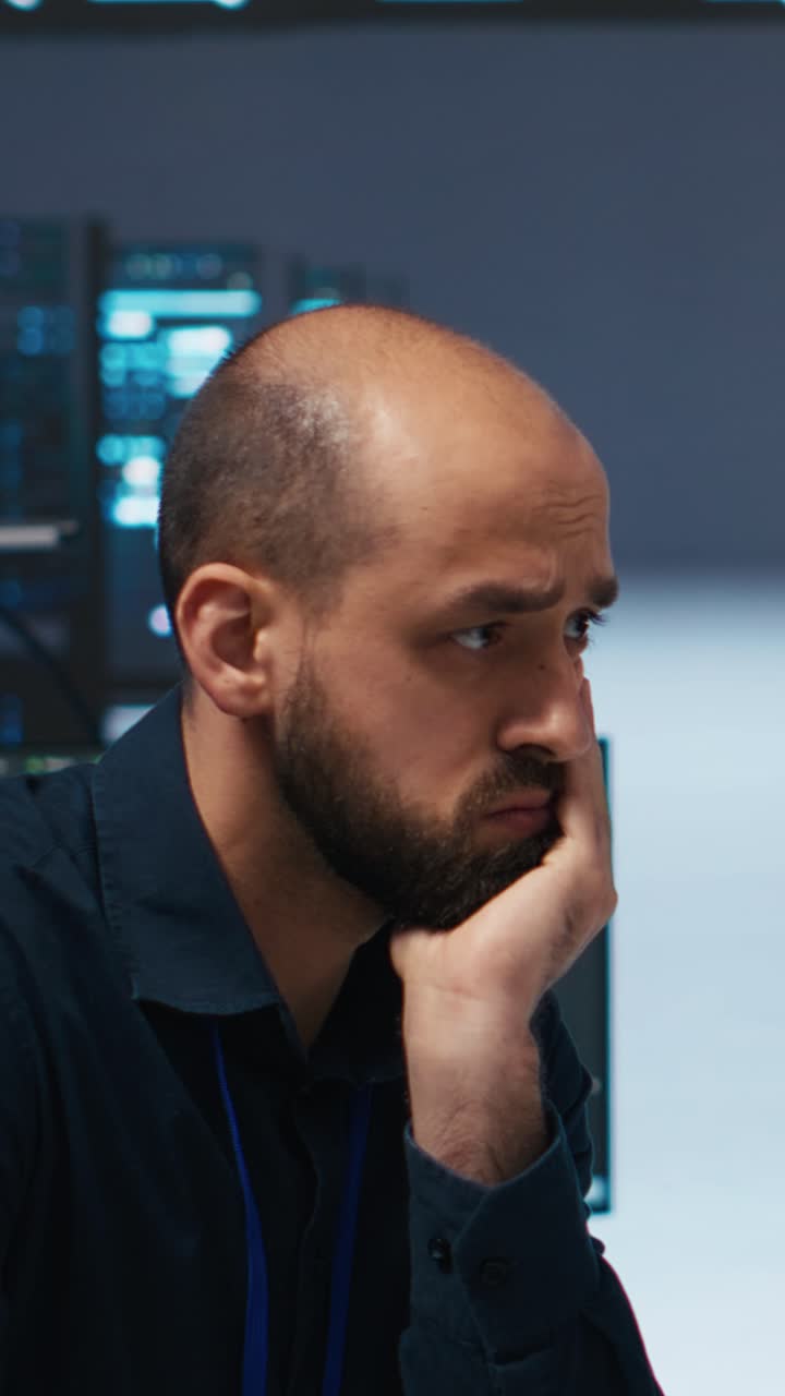 IT Professional Working on Computer in Server Room