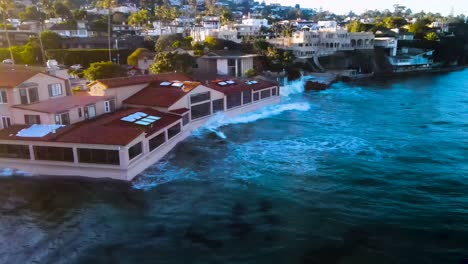 waves crashing into waterfront homes