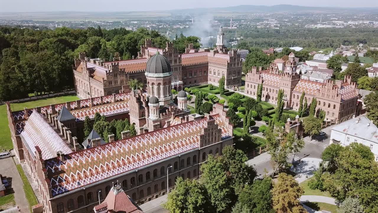Ukraine,Chernivtsi University's drone footage on a sunny summer day,footage slightly turns around the university building from right towards left. Roofs,gardens,towers and the city beyond are visible