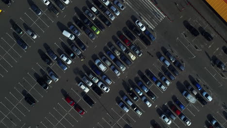 aerial view of people going at parking lot. copter flying above cars on parking