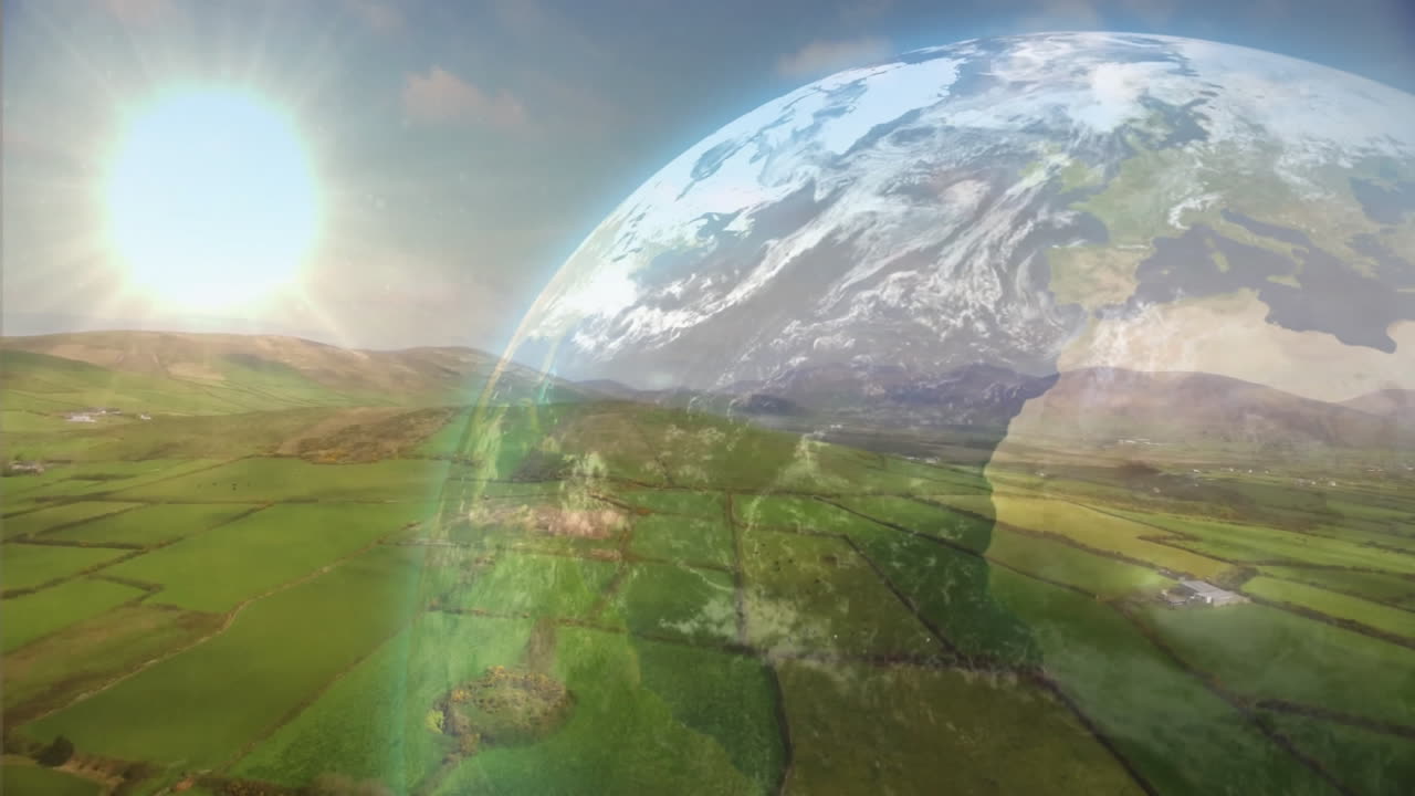 3D render showing Earth globe floating above hedgerows dividing green fields under bright sun rays