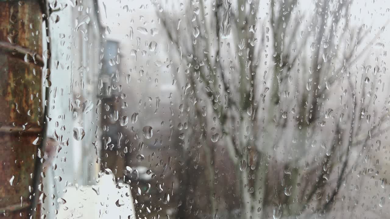 Rain drops sliding on window glass