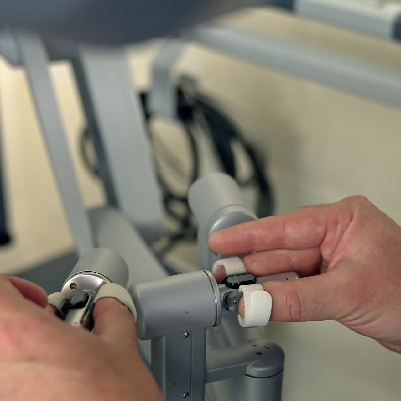 Careful hands of doctor operating the robotic equipment. Manual control of Da Vinci robot in surgery room close up