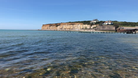 View-of-the-ocean-and-a-seaside-town-by-the-cliffs-on-the-south-coast-of-England,-taken-on-a-bright-sunny-day