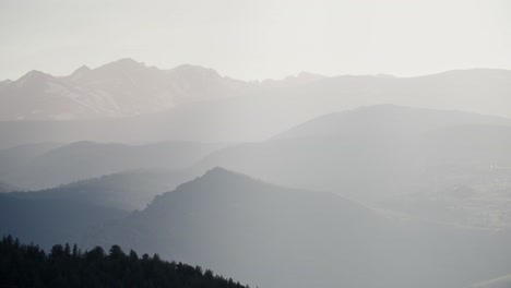 The-peaks-of-the-Rocky-Mountains-layered-through-atmospheric-haze-seen-from-Boulder,-Colorado,-USA