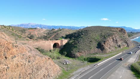 old bridge on coast road in southern spain with views over the mountains with clear visibility on bright sunny day