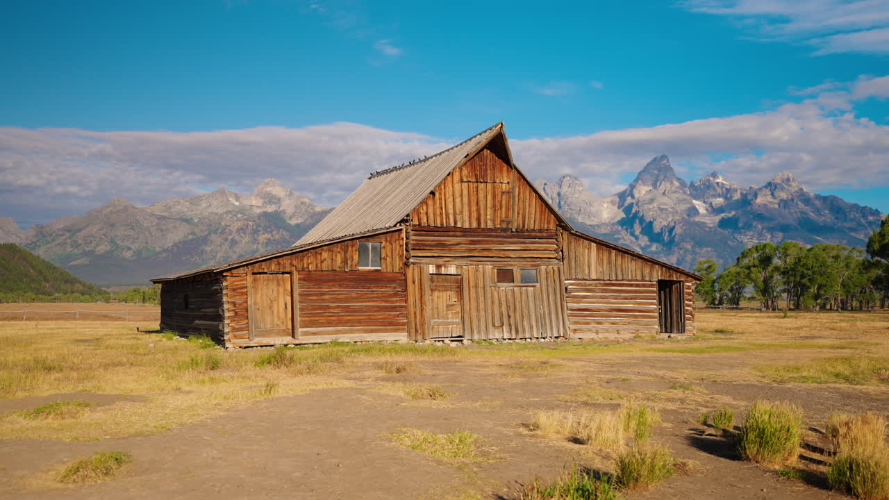 Historic Wooden Barn with Grand Teton Mountains in Background