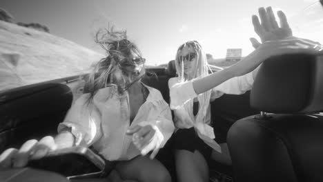 joyful friends on a convertible road trip