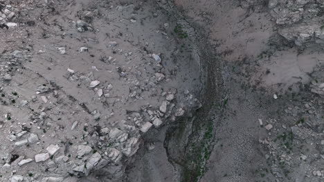 aerial view looking down over rocky waterless drought gorge of sau reservoir, catalonia, spain