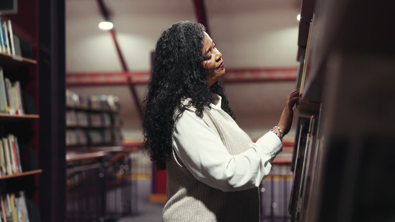 Woman browsing books in library