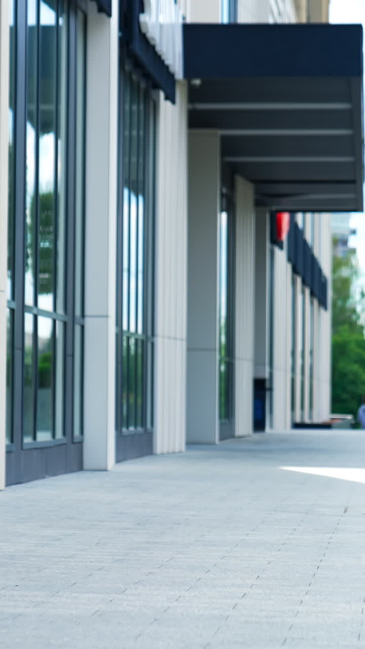Stylish young woman in fashionable clothes outdoors. Lady in jacket and cap and black heavy boots walking by the street. Vertical video
