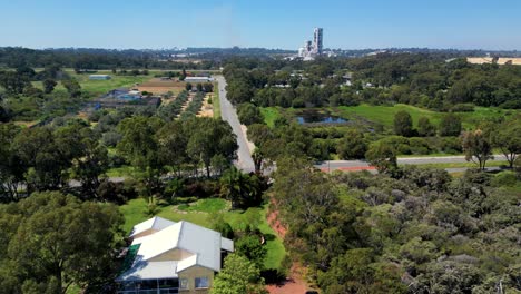 Lake-Coogee-Suburb-Overlooking-Beeliar-Regional-Park,-Cockburn-Rd---Aerial-Flyover-on-Summer-Clear-Sky-Day