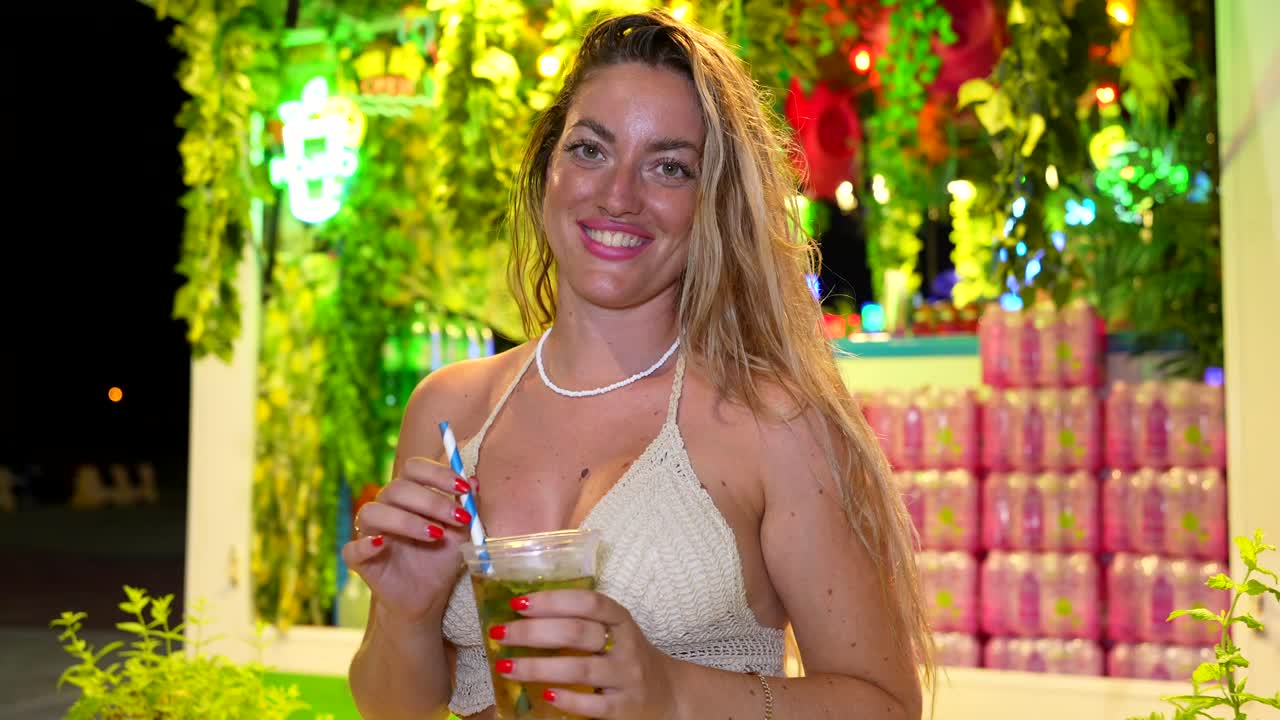 Woman enjoying a cocktail at a party