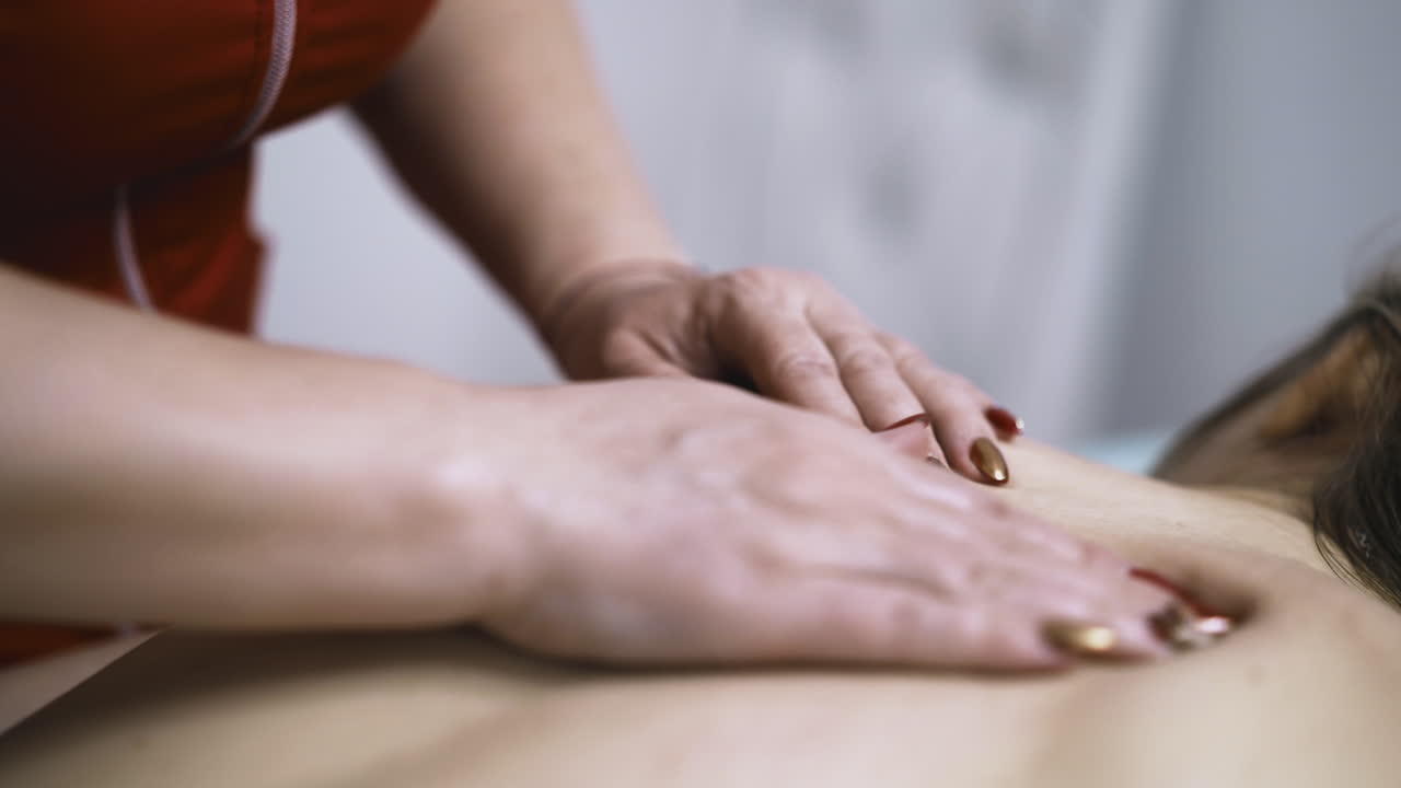 Patient får massage af dygtig terapeut i salon.