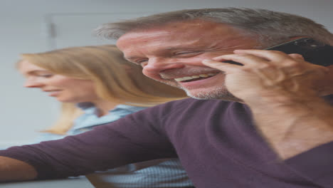 Vertical-Video-Of-Customers-In-Coffee-Shop-Window-Working-On-Laptops-And-Making-Call-On-Mobile-Phone