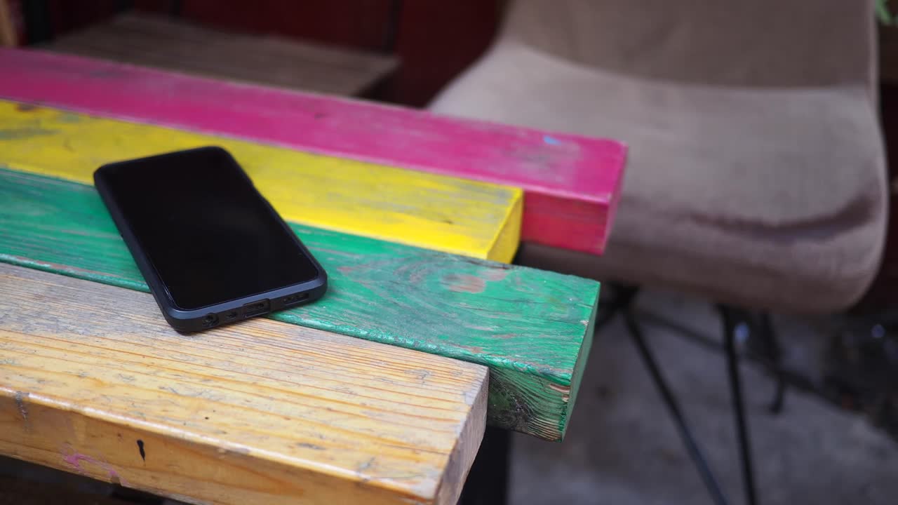 Smartphone on a colorful wooden table