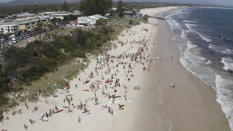 4k drone orbiting shot of people protesting on the beautiful beach against norwegian oil company, equinor, at byron bay, new south wales, australia - 2019