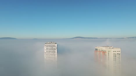 Sun-kissed-aerial:-Drone-navigates-in-between-two-towering-skyscrapers-as-it-turns-right