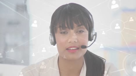 Animation-of-networks-of-connections-with-icons-over-businesswoman-using-phone-headsets