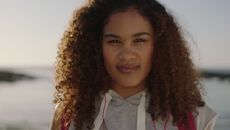 portrait of relaxed young mixed race woman smiling enjoying sunny day on beach