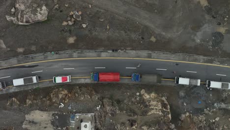 aerial drone top down shot over the congested road along the mountain slope after landslide over skardu road, pakistan at daytime