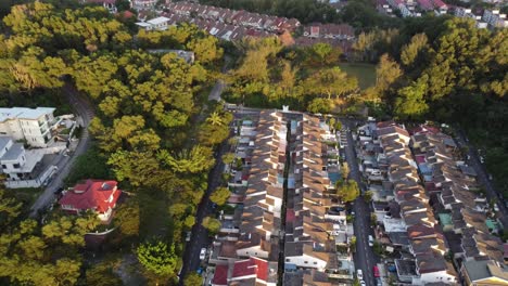 includes sunset lit lush greenery surrounding low housing area