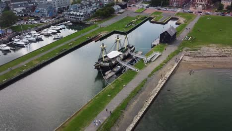 Aerial-footage-circling-around-a-historical-sailing-vessel-in-Salem,-Massachusetts