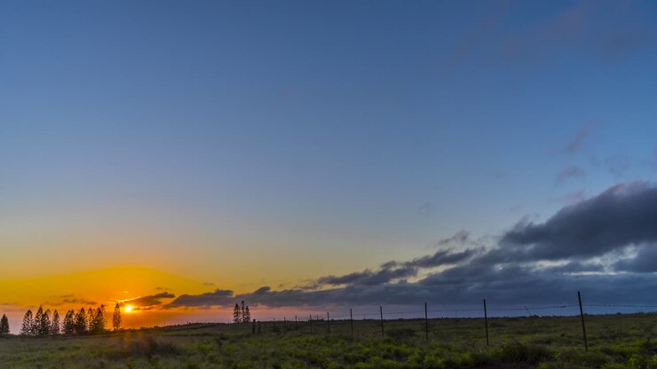 Gorgeous tropical clouds move in timelapse on the horizon as the sun sets
