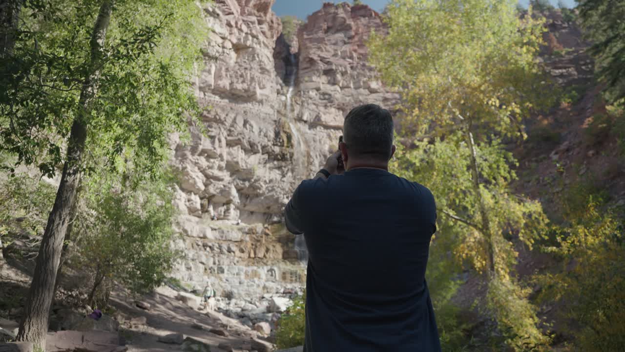 Scenic Waterfall Landscape with Photographer