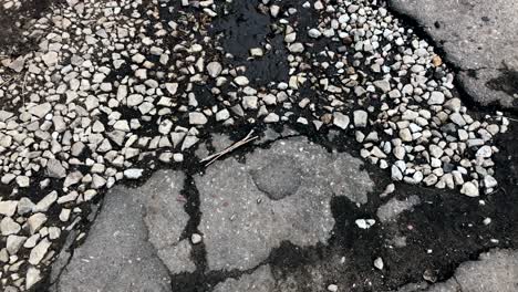 damaged asphalt road with potholes