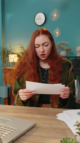 businesswoman girl opening envelope reading bad news in letter feels upset bankruptcy at home office