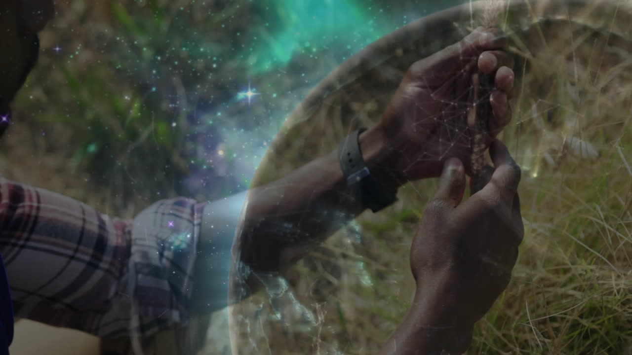 Man kneeling wearing smartwatch holding prayer beads, featuring globe and stars for technology