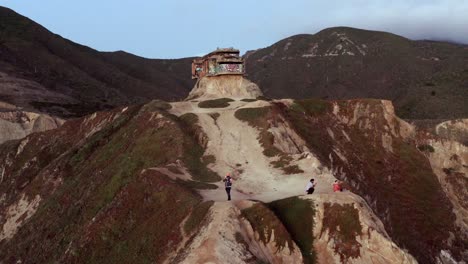 AERIAL:-drone,-devil's-slide-bunker-and-people-by-the-cliff,-steady-view