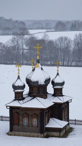 snowy wooden church in winter landscape