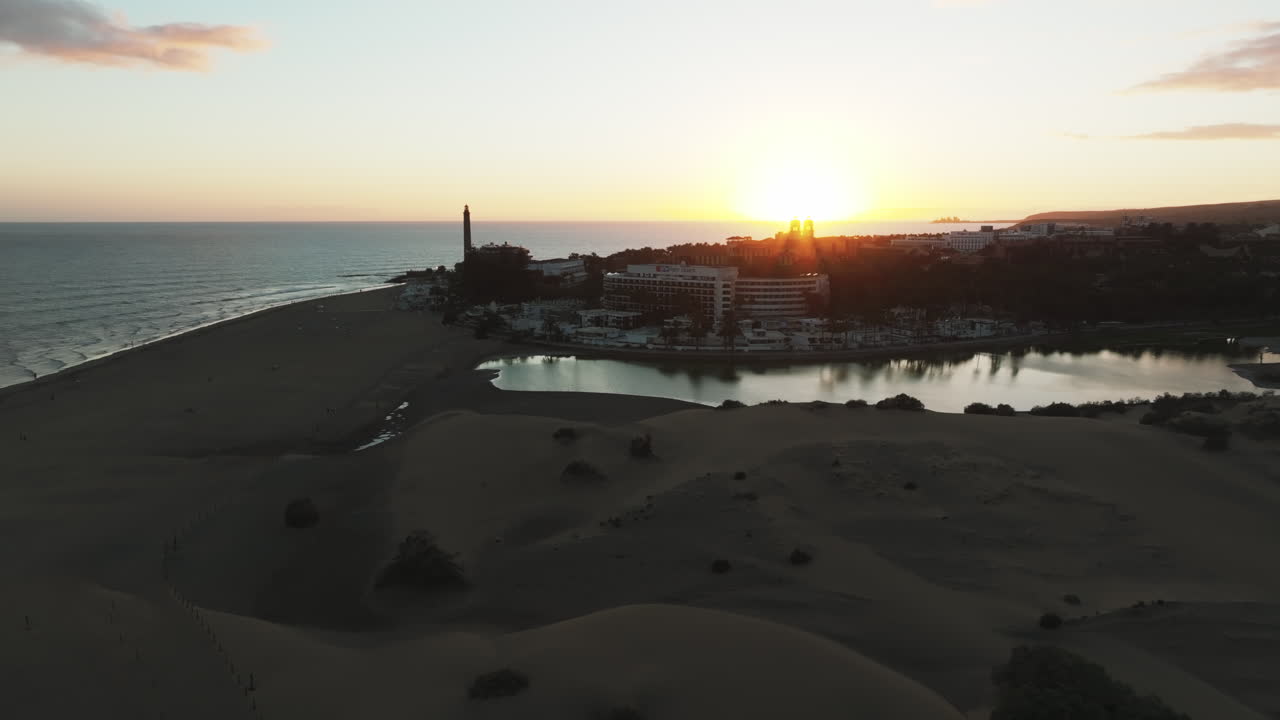 dunas de maspalomas: vista aérea en órbita durante la puesta del sol sobre las dunas y la laguna de esta área natural