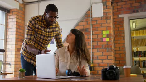 graphic designers working together at desk in a modern office 4k