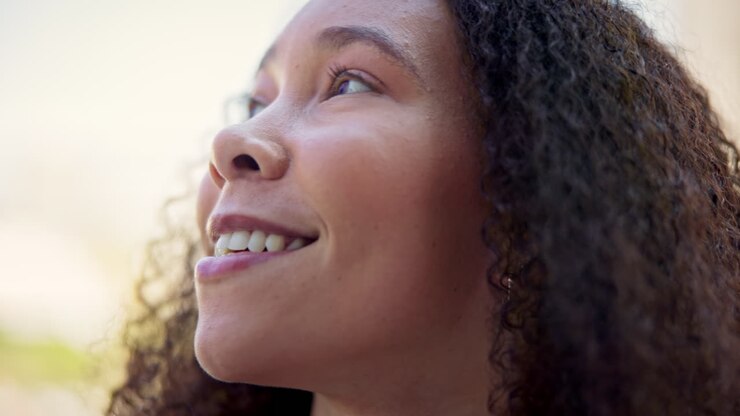 Face, thinking and smile with a woman outdoor