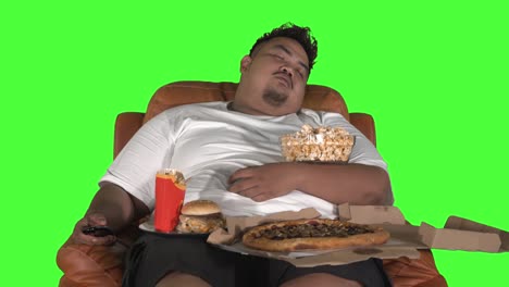 fat man looks gorged and sleeping on the sofa