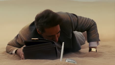exhausted businessman lying face down in a sandy desert