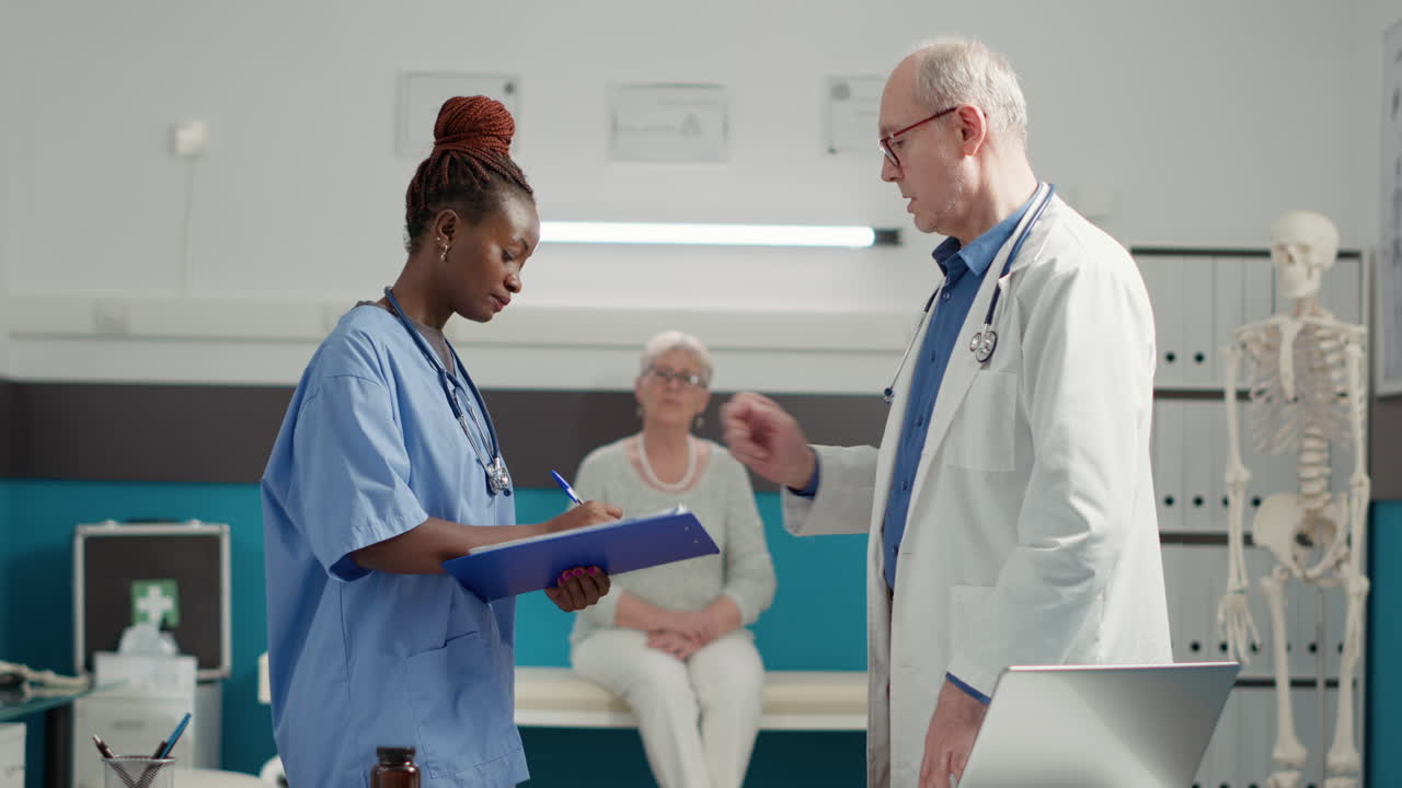 Multiethnic team of doctor and nurse looking at diagnosis results