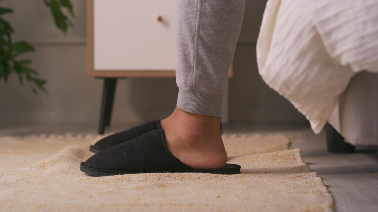 Putting on slippers in the bedroom
