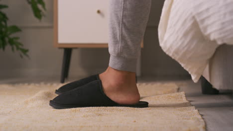 putting on slippers in the bedroom