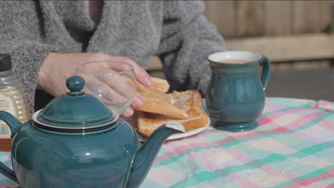 person enjoys toast in traditional english breakfast outdoors, slow-mo