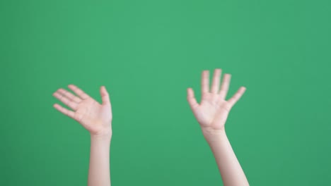 kid hands waving saying greeting, goodbye making hand gestures on chroma key green screen background