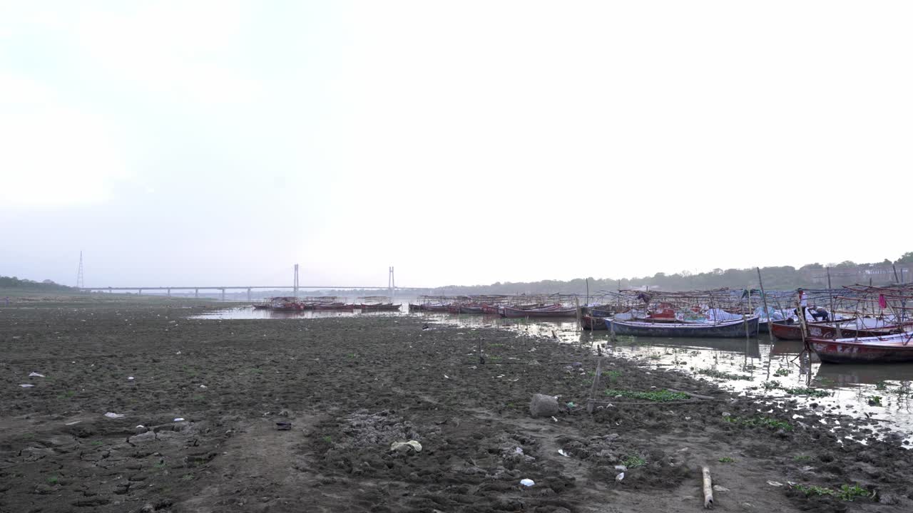 Dry Riverbed with Boats and Bridge in India
