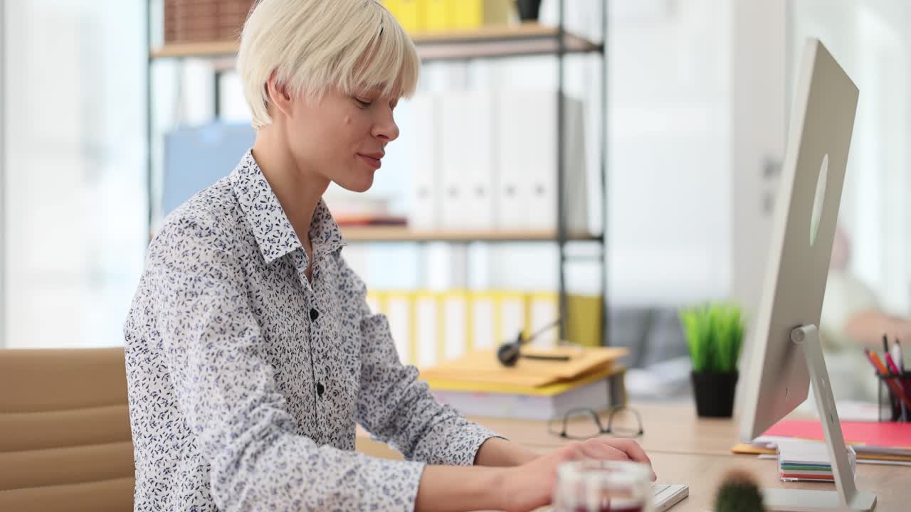 Woman working on a computer at an office desk