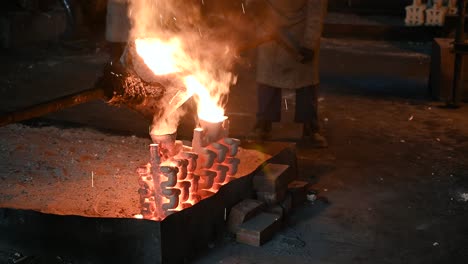 Close-up-of-pouring-process-of-molten-metal-used-in-casting