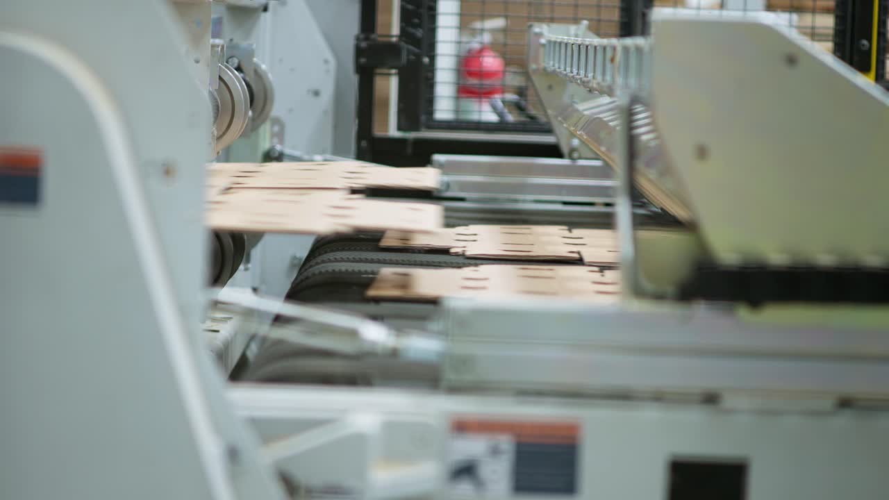 SLOW MOTION SHOT OF A CARDBOARD BOX MACHINE